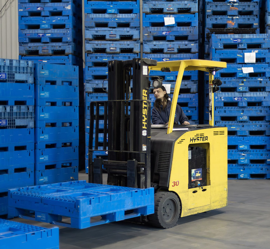 Forklift operation moving returnable containers at Container Pros